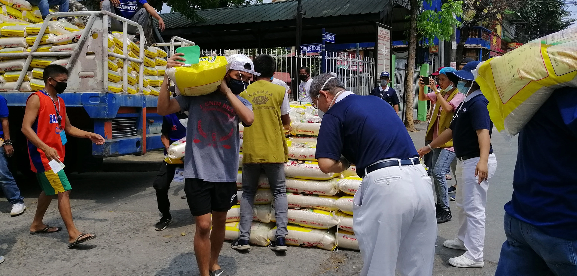 志工戴口罩、防護面罩、防護帽及手套進行發放，儘管因疫情需保持距離，但人與人之間的溫情無距。