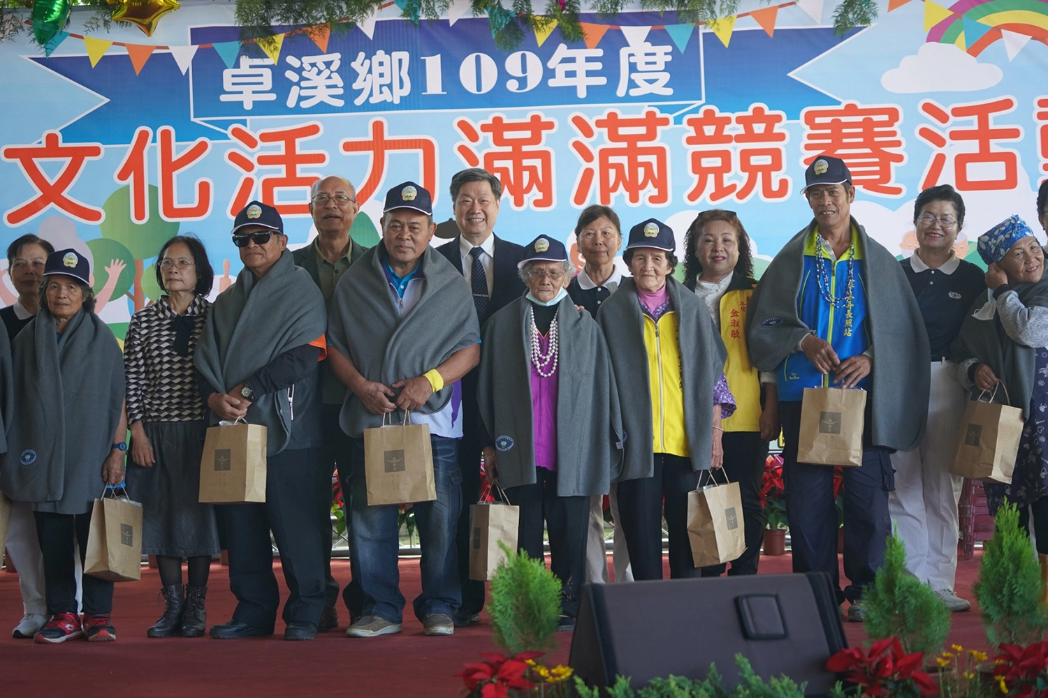 玉里慈濟志工為卓溪鄉長者披上披肩，祝福長者身體健康。 攝影：王嘉彬