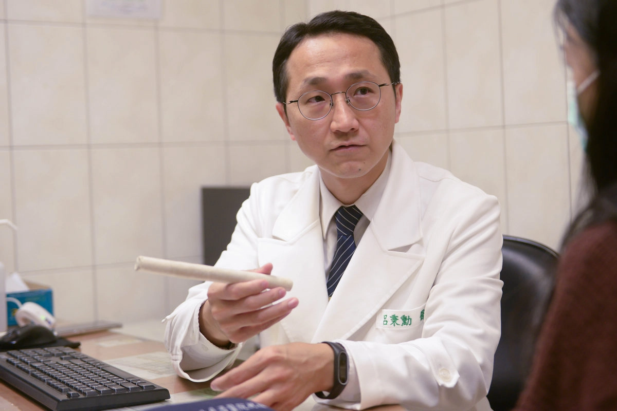 呂秉勳醫師向病人說明艾灸的方法。