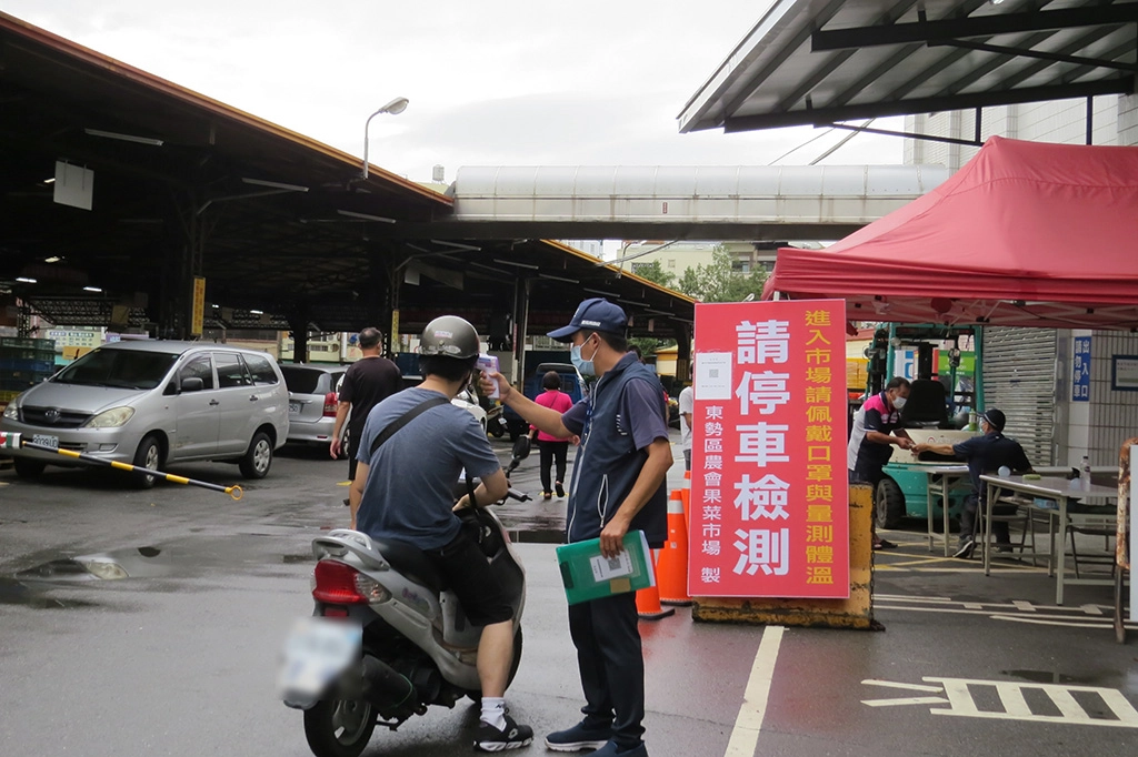 東勢區農會果菜市場落實防疫措施進入必須量測體溫。