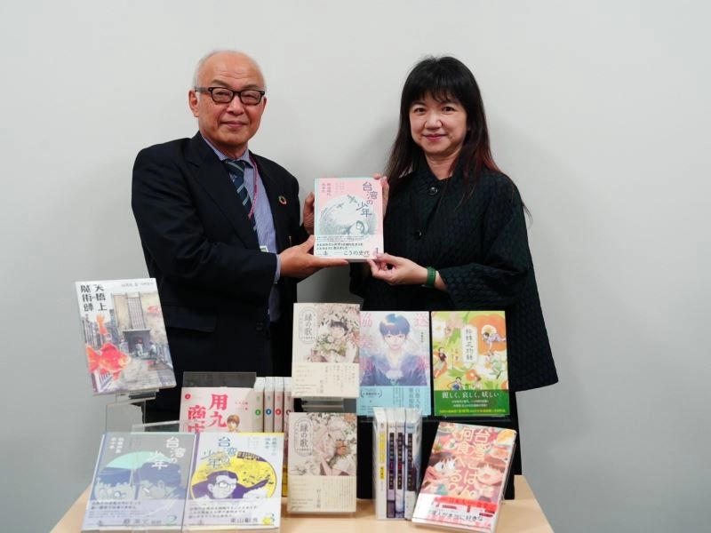 文化部政務次長李靜慧（右）致贈北九州市漫畫博物館近期在日本出版的臺灣漫畫。