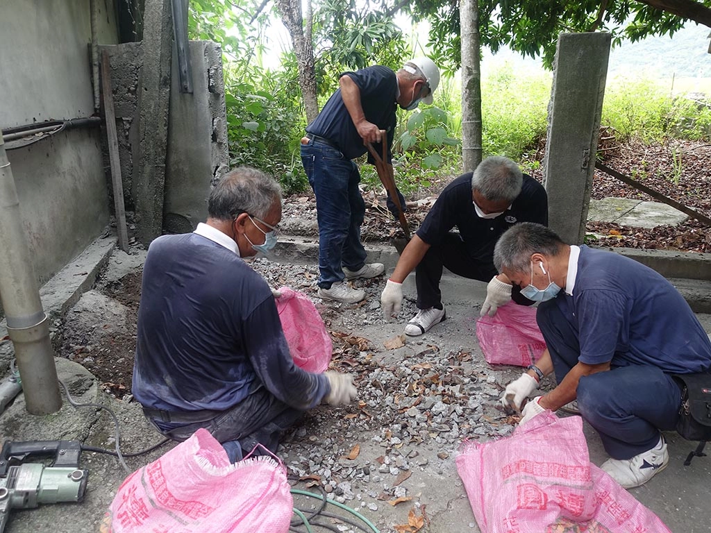 慈濟志工在玉里鎮源城里為民眾修繕，志工整理廢棄物。