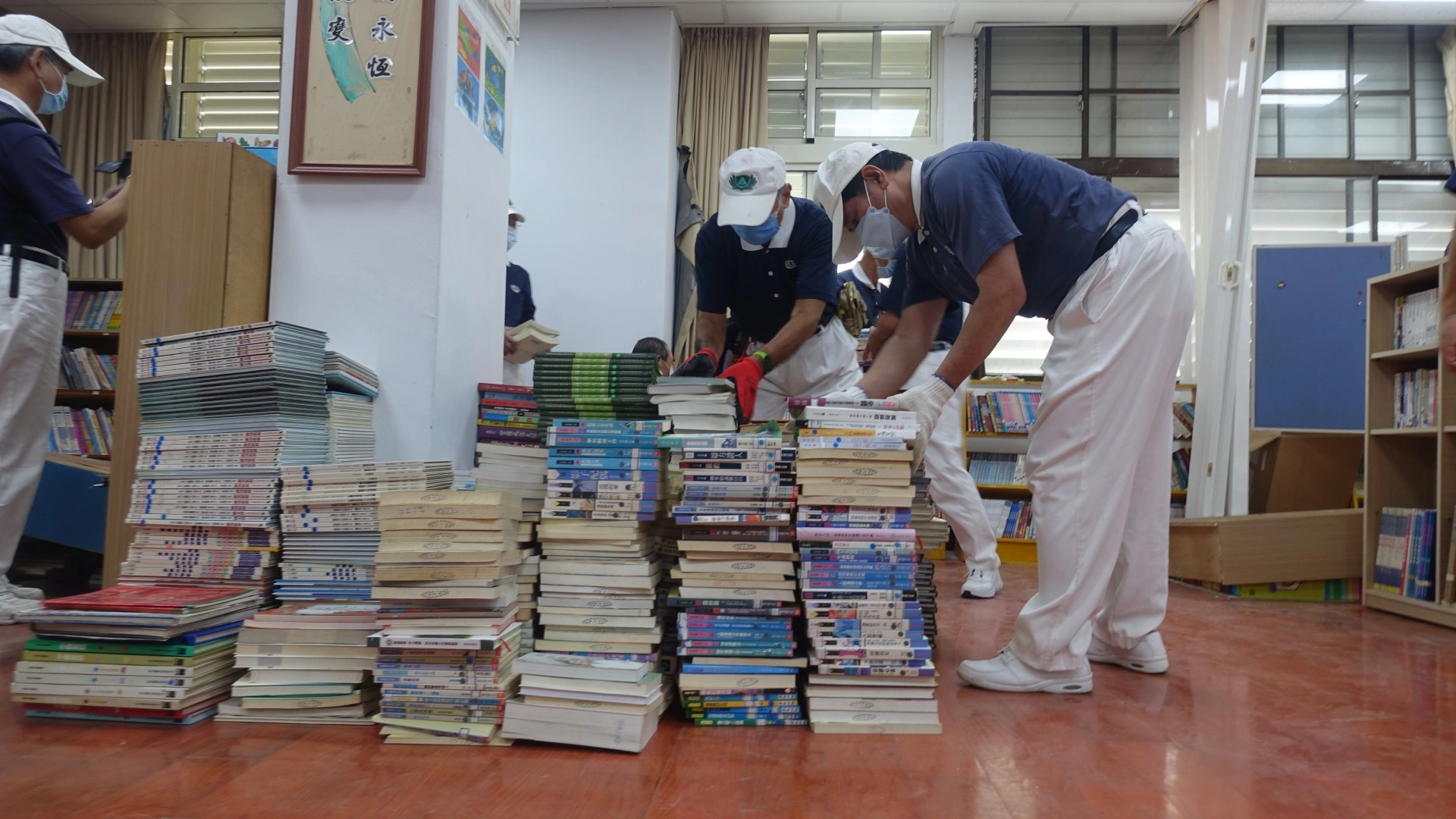 慈濟志工9月20日前往富里鄉萬寧國小協助災後復原，圖為志工整理圖書館毀損的書櫃與書籍。
