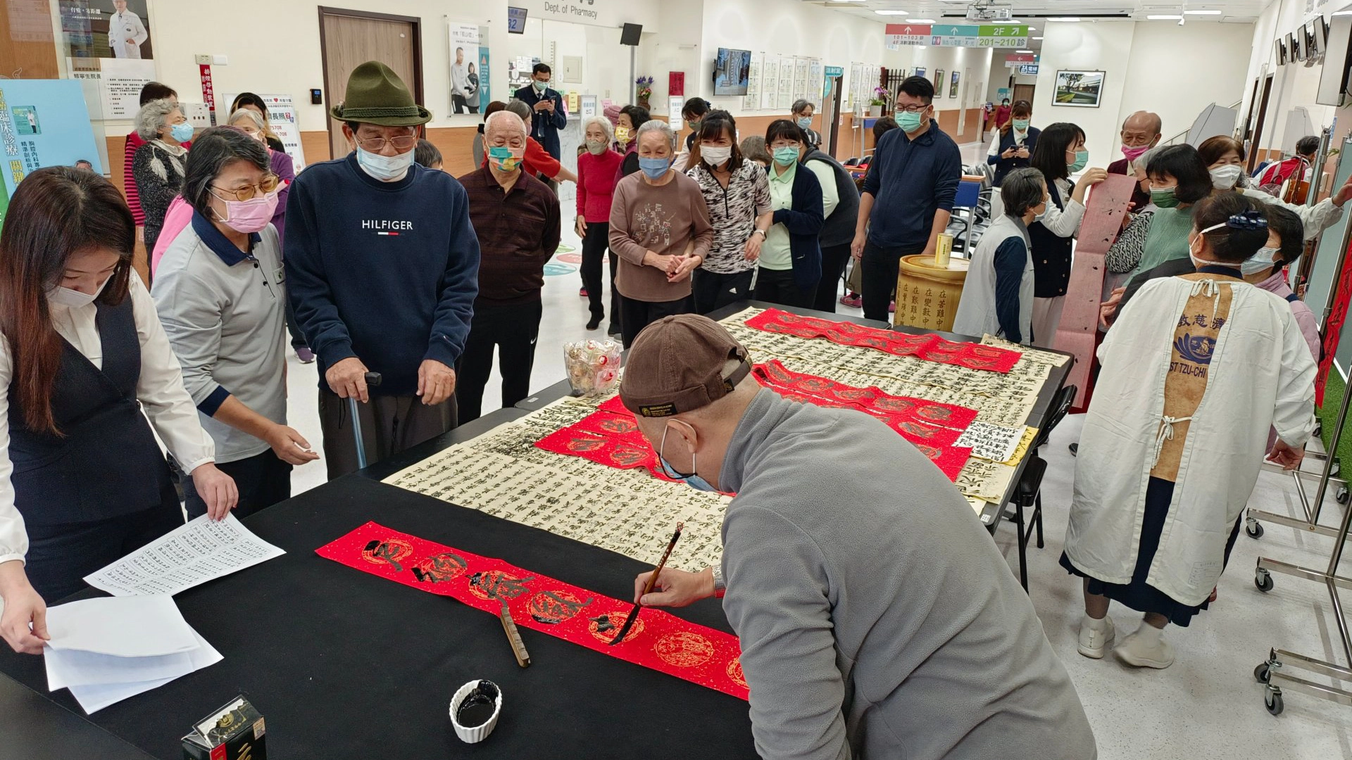 嘉義慈濟診所宏兔大展迎新年揮毫現場，民眾熱鬧索春聯