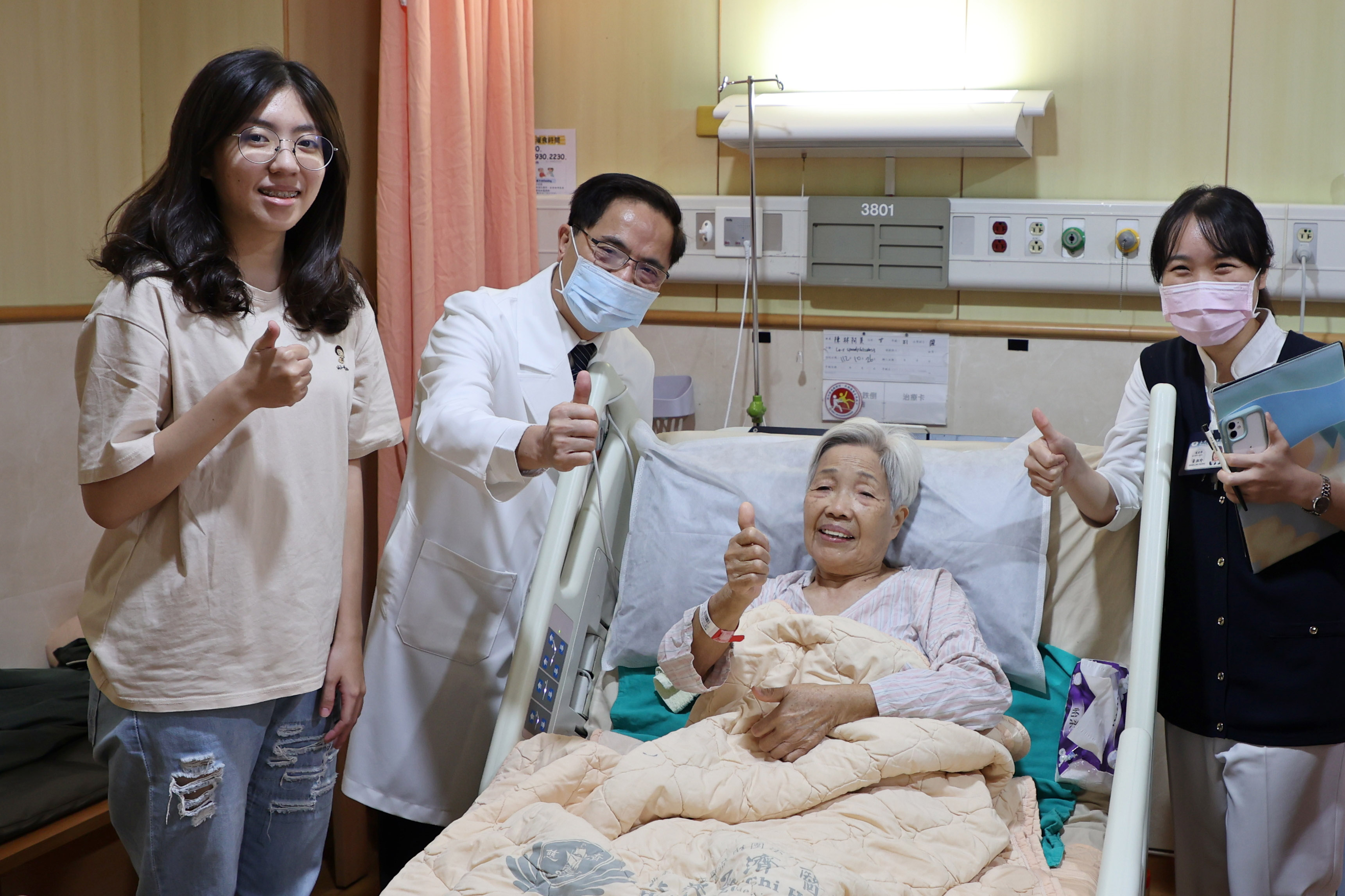 林欣榮院長(左二)至病房探視因準備出院而精神很好的郭奶奶，並與孫女(左一)、專師黃湘玲(右一)開心合影。