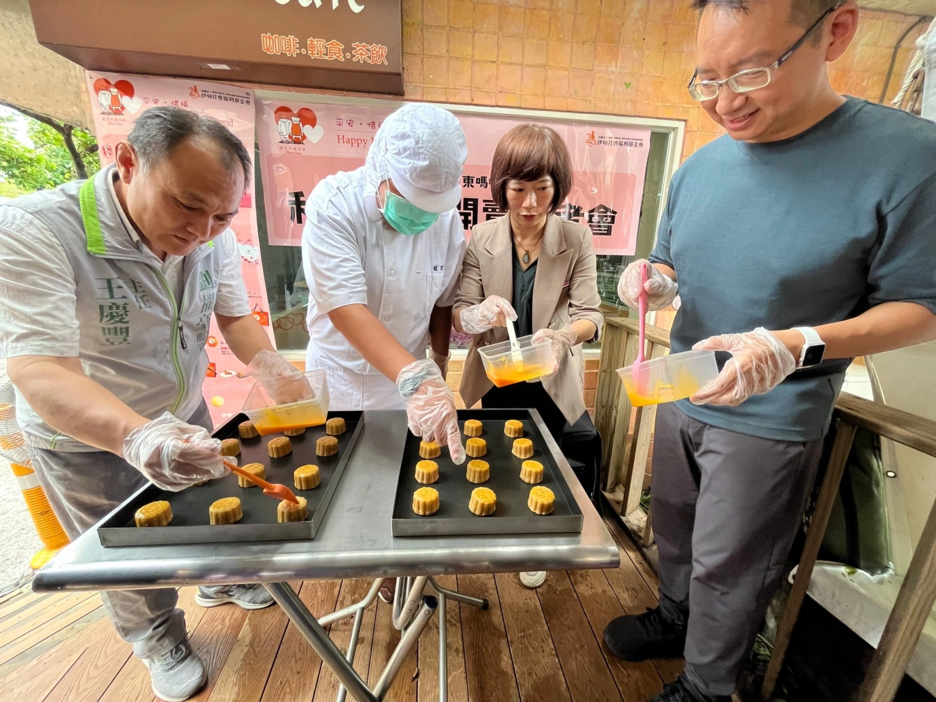 庇護員工翰翰(左二)穿上廚師服，帶領貴賓體驗月餅製作。