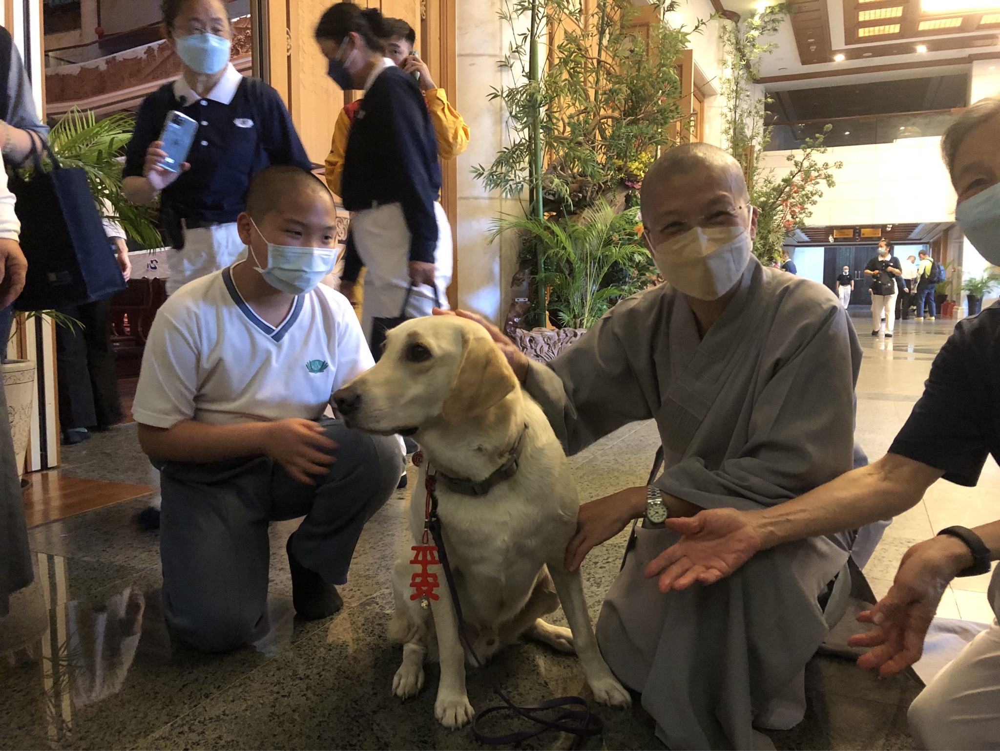 出席在花蓮靜思堂舉辦安心祈福會的花蓮縣消防局搜救犬Hero，獲靜思精舍法師贈予「平安」吊飾。