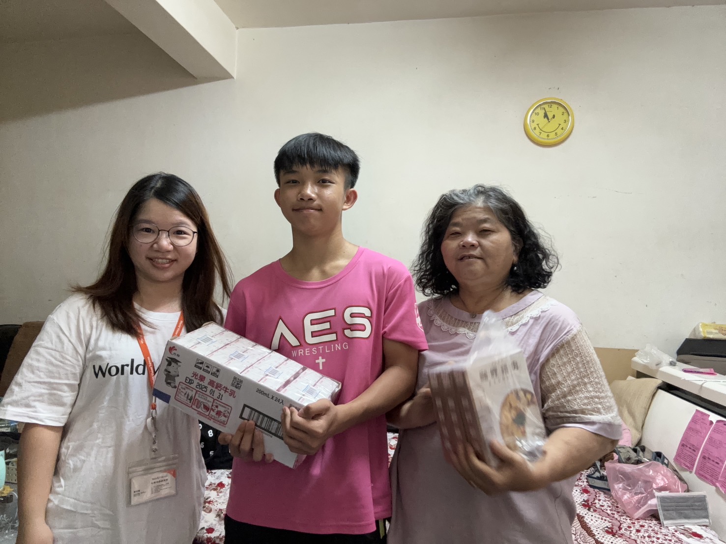善良的張祖銘（中）是角力選手，孝順的他總是把比賽獎金留給阿嬤（右）看病，展望會也定時提供物資與協助。左為展望會社工員蔡雅菁。