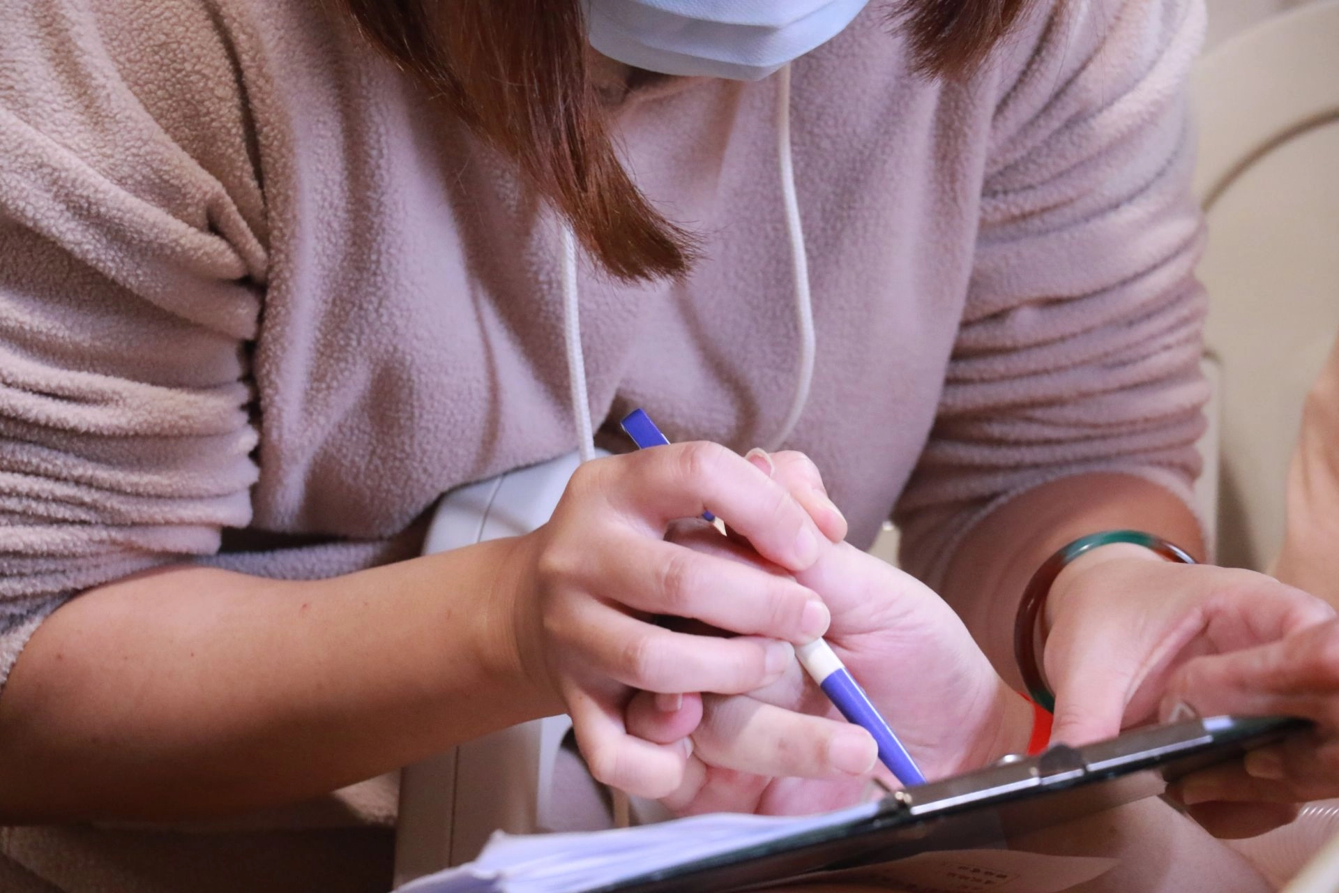 無法執筆的黃鼎承由太太協助握筆，簽屬捐贈同意書，捐出腦組織做醫學研究。