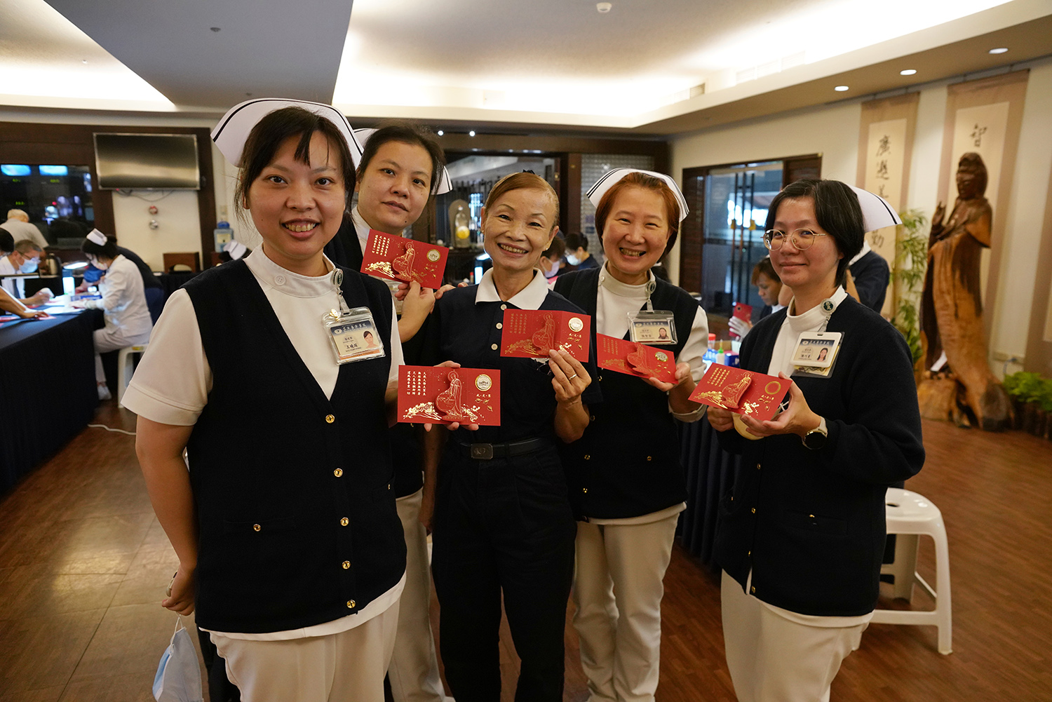 二七東王曉瑄護理長(左起)、六西許淳雅護理長、國新和氣陳梅鳳師姊，張智容督導，輕安居陳巧菱護理長，都參與福慧紅包製作。