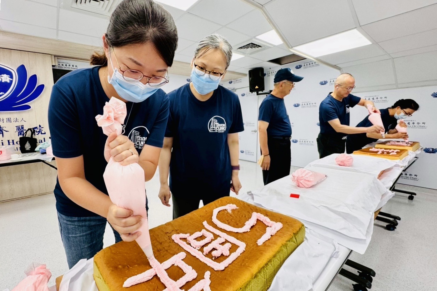 診所同仁們合力用奶油在每個蛋糕上寫上文字。