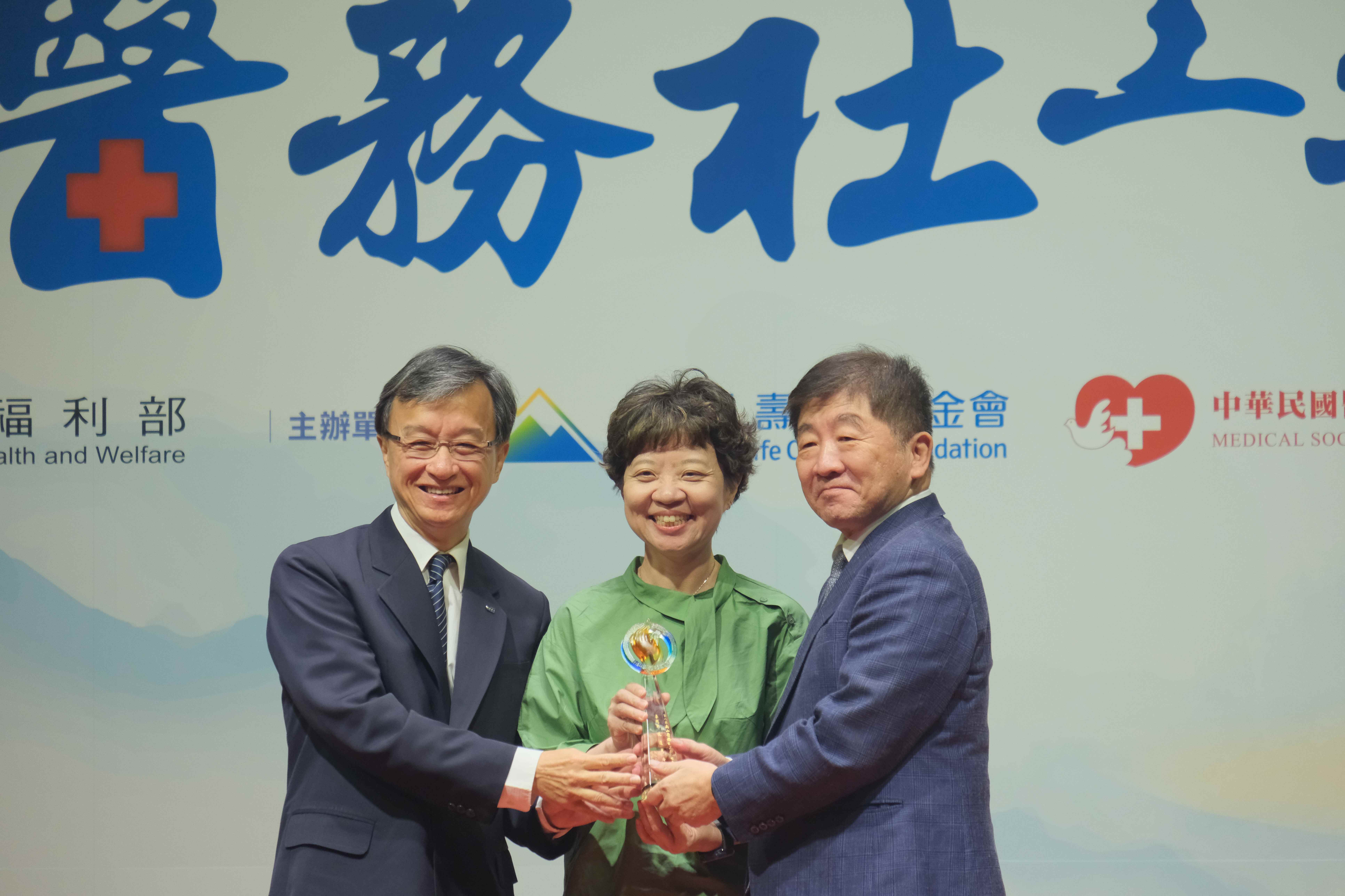 花蓮慈濟醫院社會服務室在東部特殊區域，對急難救助、婦幼保護和智慧結合跨領域專業等創新服務，獲得醫務社工團體組卓越獎。由資深顧問兼法制長李毅醫師（左一）和社服室主任謝侑書（中）接受行政院陳時中政務委員頒獎表揚。