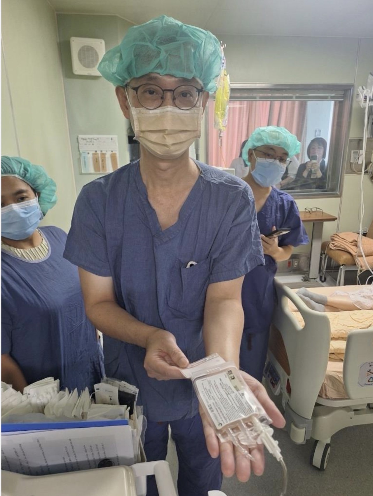 李啟誠醫師捧起10cc以病人自身細胞製作的CAR-T細胞，雖只有巴掌大，卻蘊含無限救命的生機。