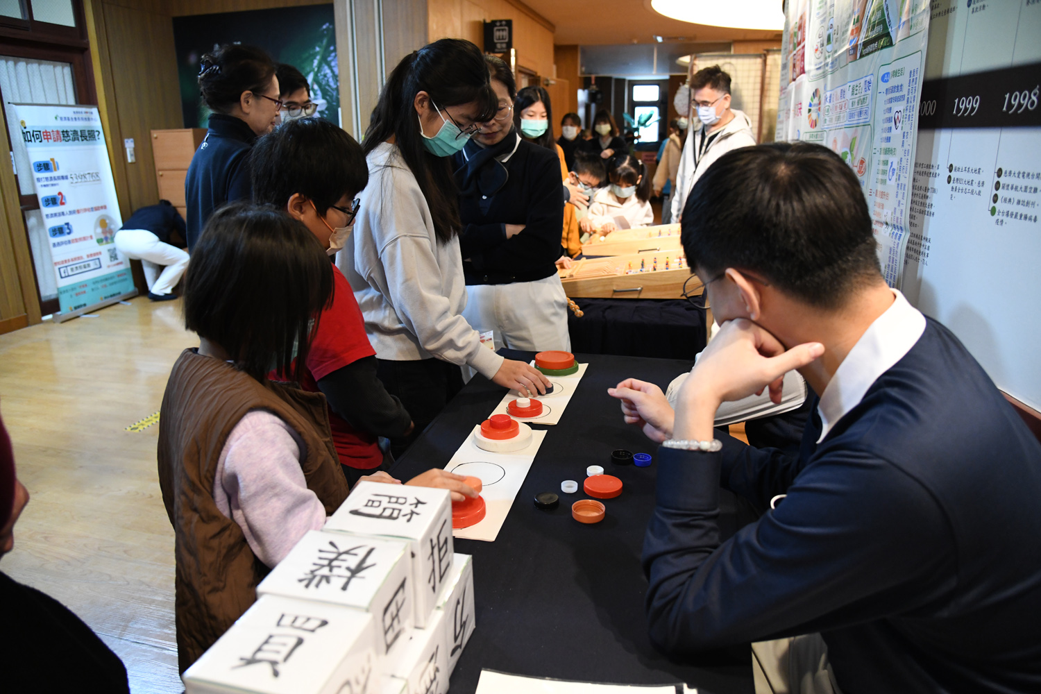 志工教導孩子「歡喜來搬家」遊戲規則,孩子們遵守遊戲規則,想盡辦法過關。