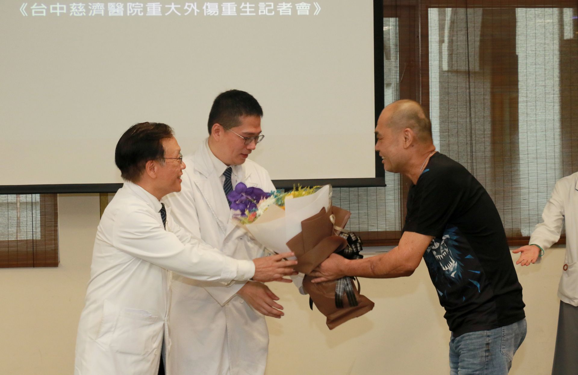 胡先生致贈花束感謝台中慈濟醫療團隊，由簡守信院長（左）、一般外科醫師高國堯（左二）代表接受。