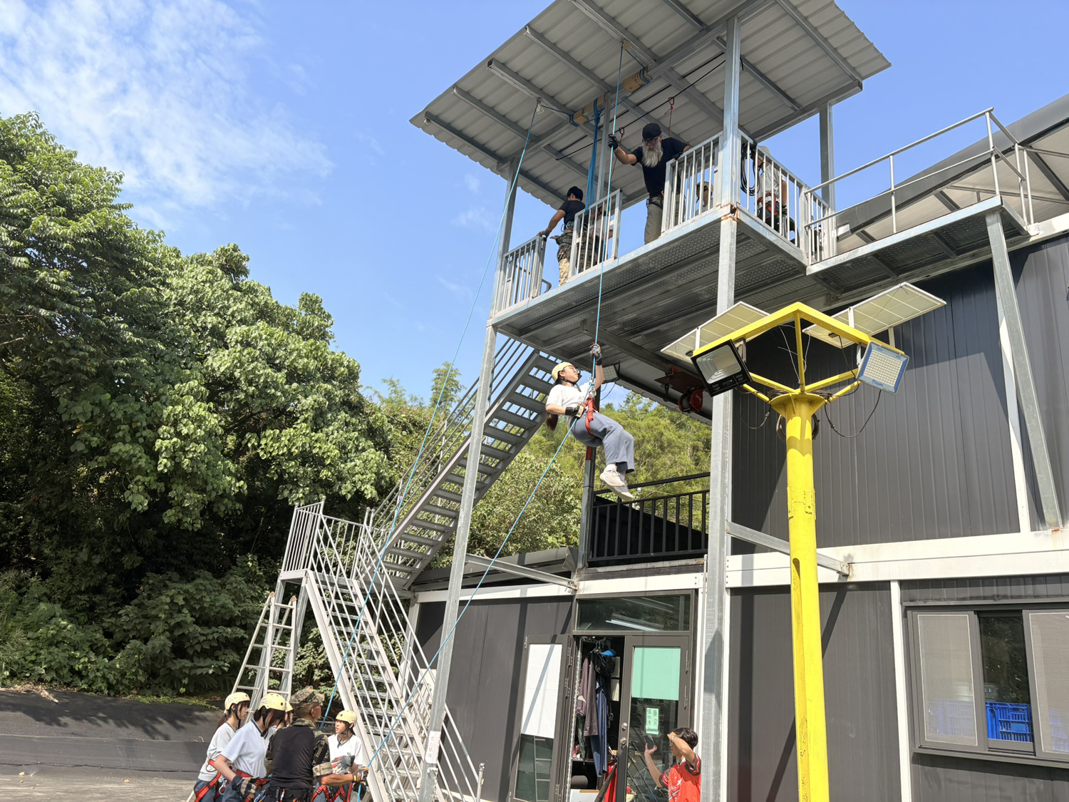 同學們克服恐懼,透過高樓垂降學習逃生技能。