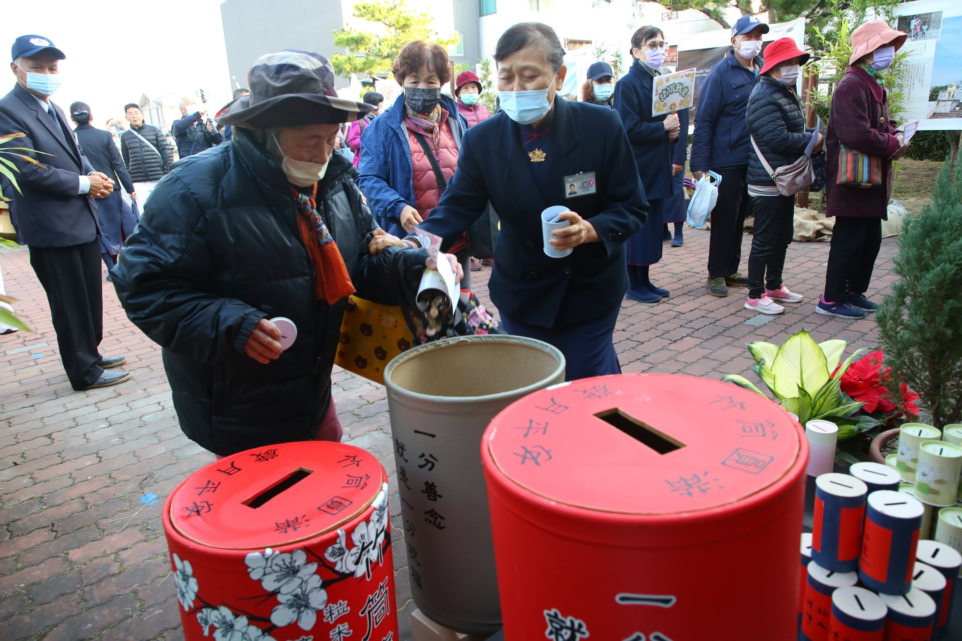 會眾帶來竹筒善款投入功德海助人
