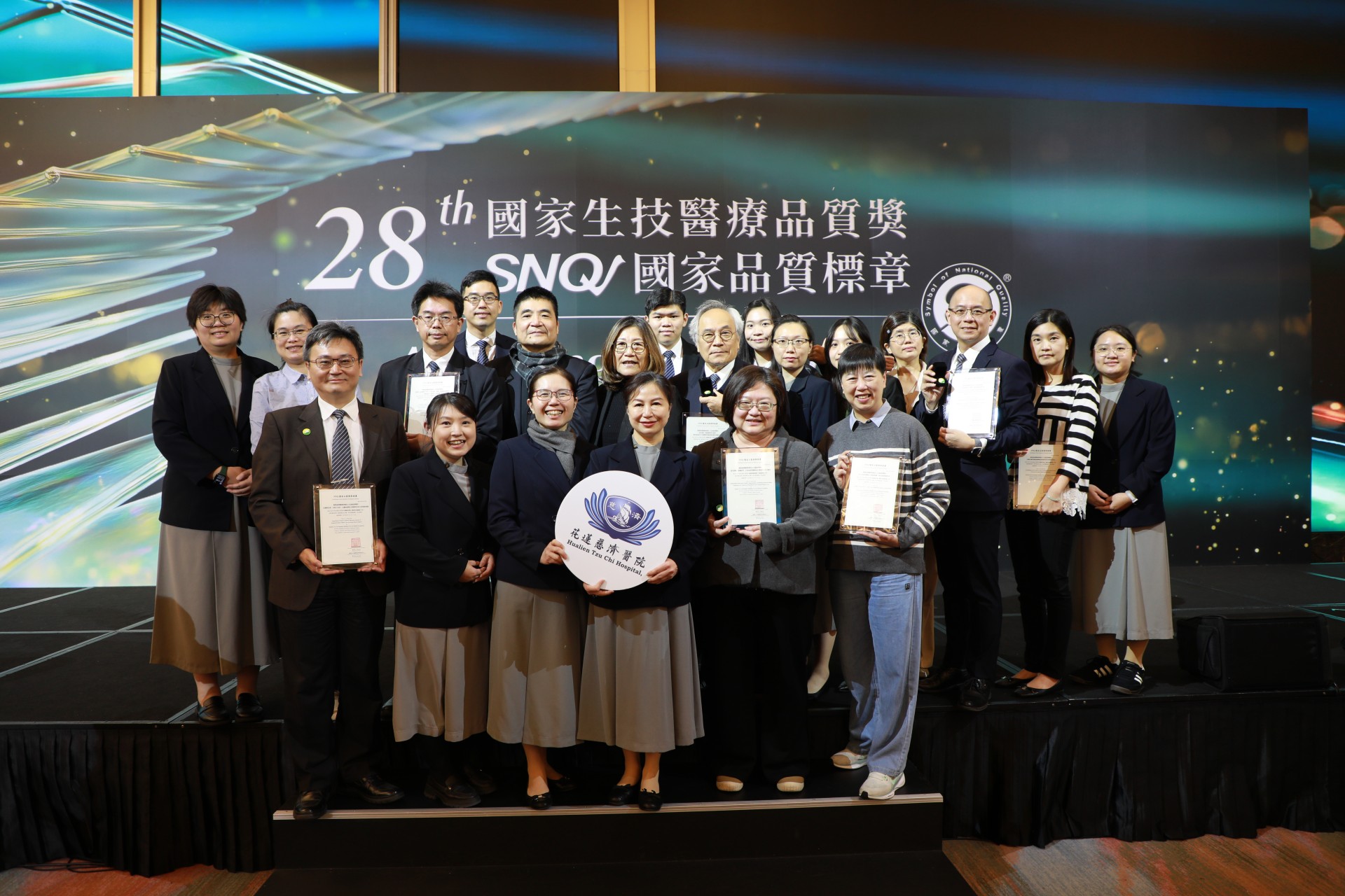 醫事室主任張菁育(前排右一)、腎臟內科血液透析室護理長林欣穎(前排右二).分別代表接受SNQ國家品質標章受獎，與院內與會團隊合照。