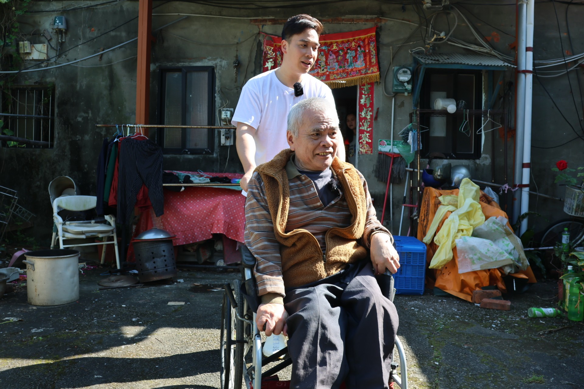 無尊推著潘伯伯到戶外曬太陽，完成70歲的生日願望