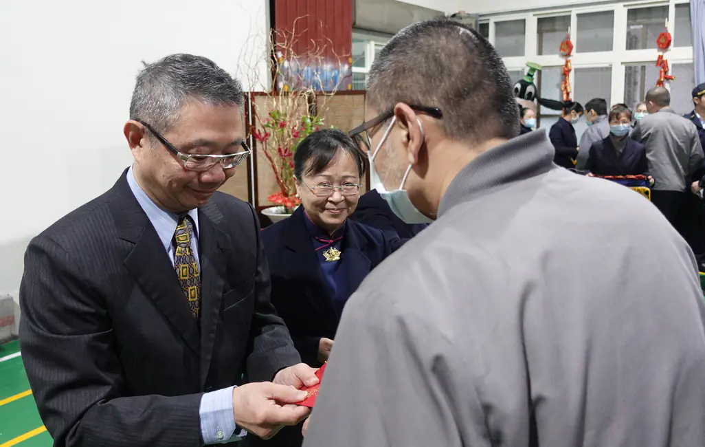 典獄長與慈濟志工們致贈收容人福慧紅包。